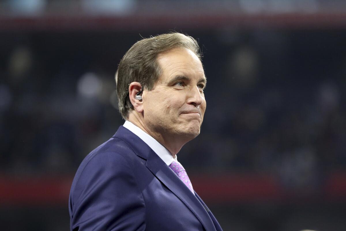 CBS announcer Jim Nantz stands on the field after the Super Bowl.