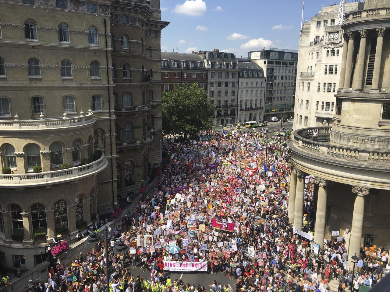 Protesters for the "Stop Trump" women's march gather in London. Trump's pomp-filled welcome to Britain was overshadowed Friday by an explosive interview in which he blasted Prime Minister Theresa May, blamed London's mayor for terror attacks against the city and argued that Europe was "losing its culture" because of immigration.