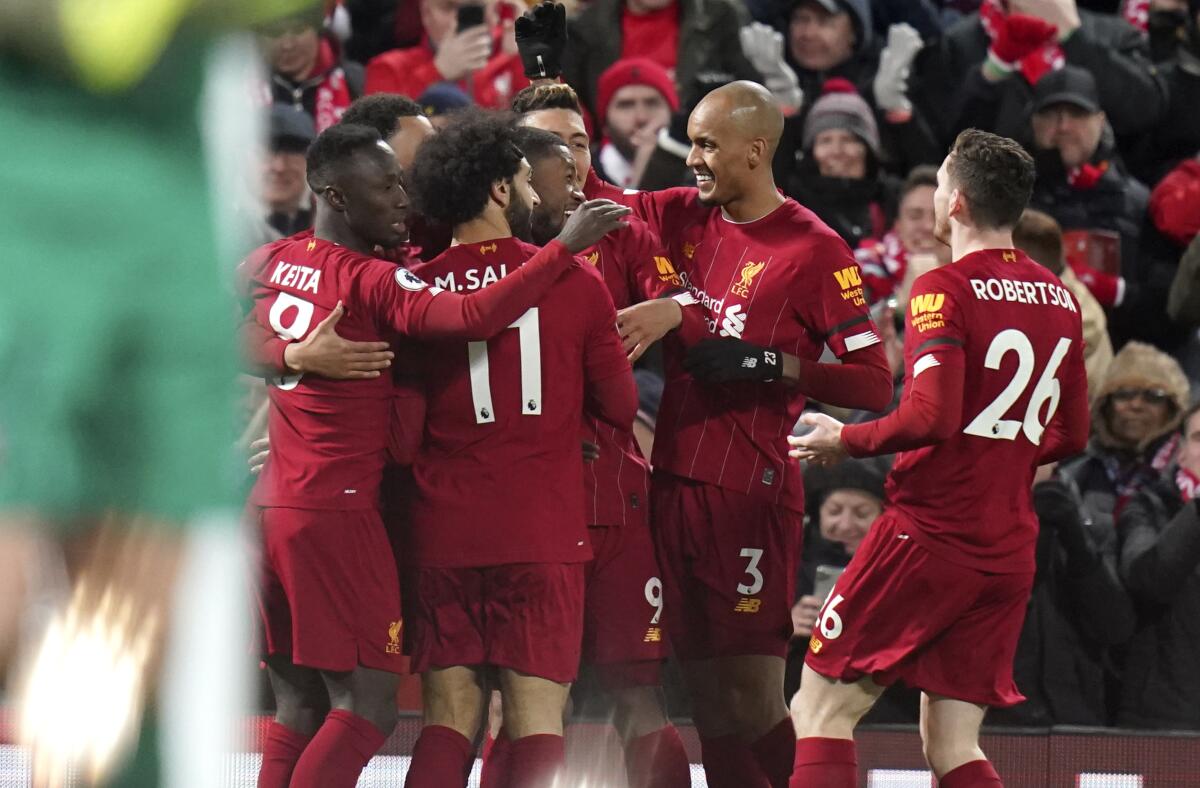 Liverpool players celebrate their goal during the English Premier League soccer match between Liverpool and West Ham in Liverpool, England on Monday.