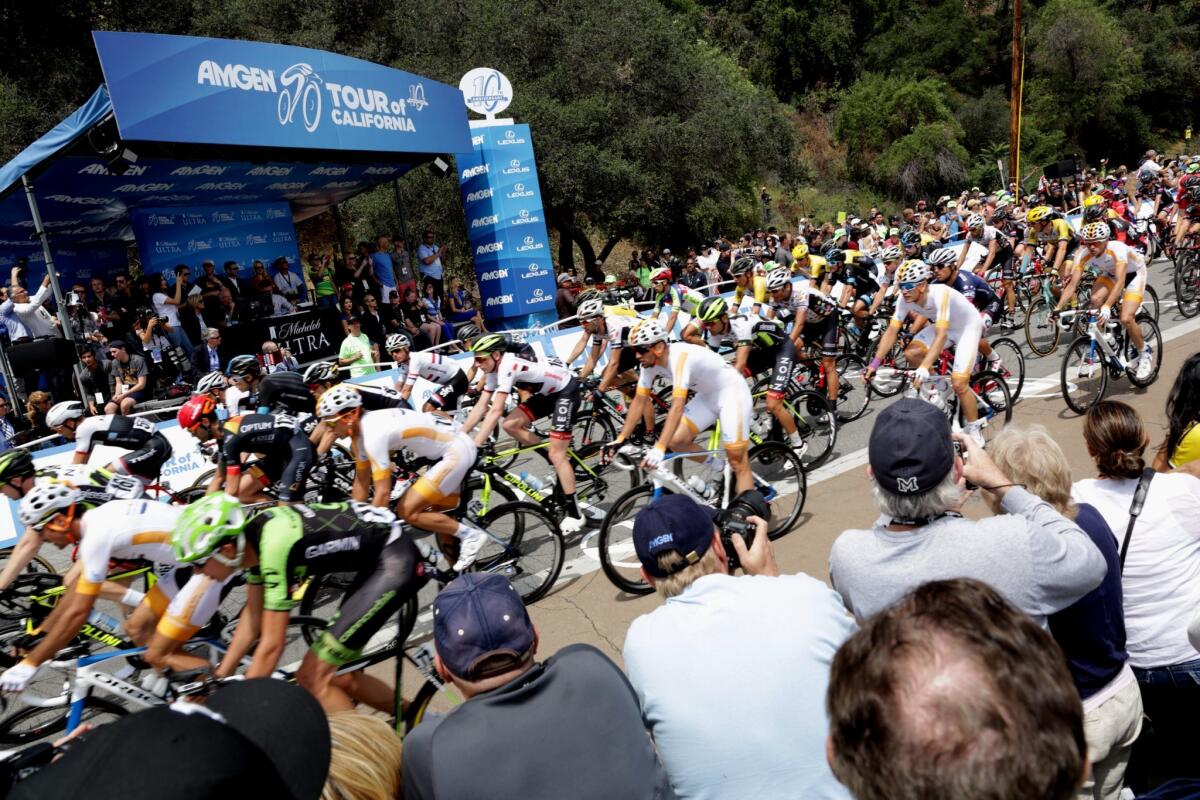 Racers speed by the finish line as they make laps around the Rose Bowl during the Amgen Tour of California on May 17.