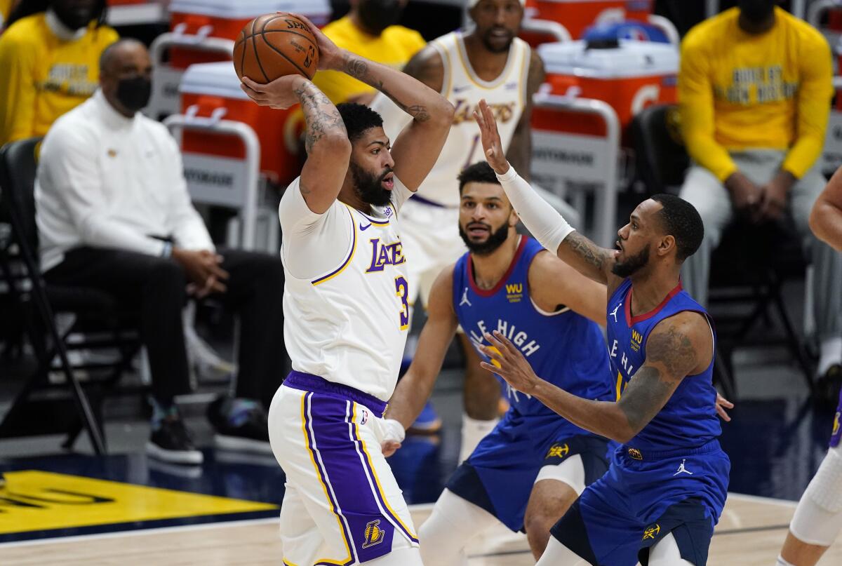 Lakers forward Anthony Davis looks to pass the ball.