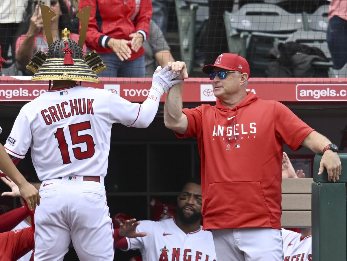  Phil Nevin congratulates Randal Grichuk as he arrives in the dugout