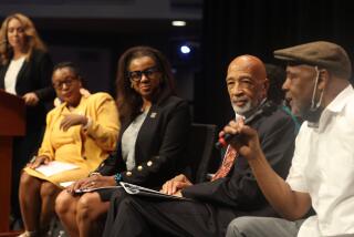 Northridge, CA - August 27: President and CEO of New World Education Mandla Kayise speaks as resident & CEO of the Los Angeles Urban League Michael Lawson, second from right, Capri Maddox, third from right, Khansa Jones Muhammad, second from left, and Dominique DiPrima, far left, listen during a discussion on reparations at Cal State Northridge on Tuesday, Aug. 27, 2024 in Northridge, CA. (Michael Blackshire / Los Angeles Times)