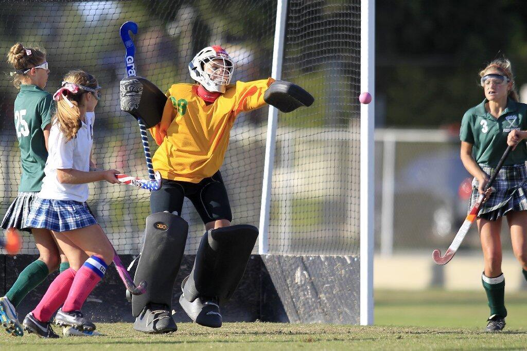 Edison High goalkeeper Hannah Heydorff, center, blocks a shot with her left hand during the second half against Newport Harbor in a Sunset League game at Davidson Field on Tuesday.
