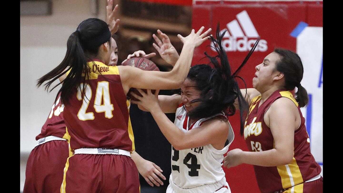 Ocean View's Emi Yamasaki, left, Michaela Fernando and Jazmine Alarcon box in Westminster's Vyna Ton during a Golden West League game on Friday, February 2.