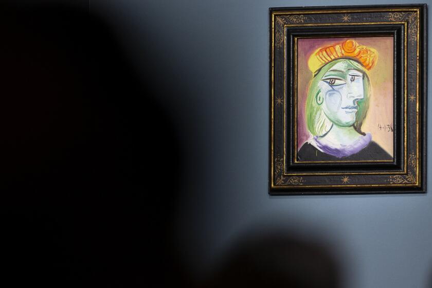 Pablo Picasso's "Femme au béret rouge-orange" is on display for auction at the Bellagio hotel and casino Saturday, Oct. 23, 2021, in Las Vegas. Sotheby's and the MGM Resorts Fine Art Collection hosted the auction, which raised $109 million from eleven pieces. (AP Photo/Ellen Schmidt)