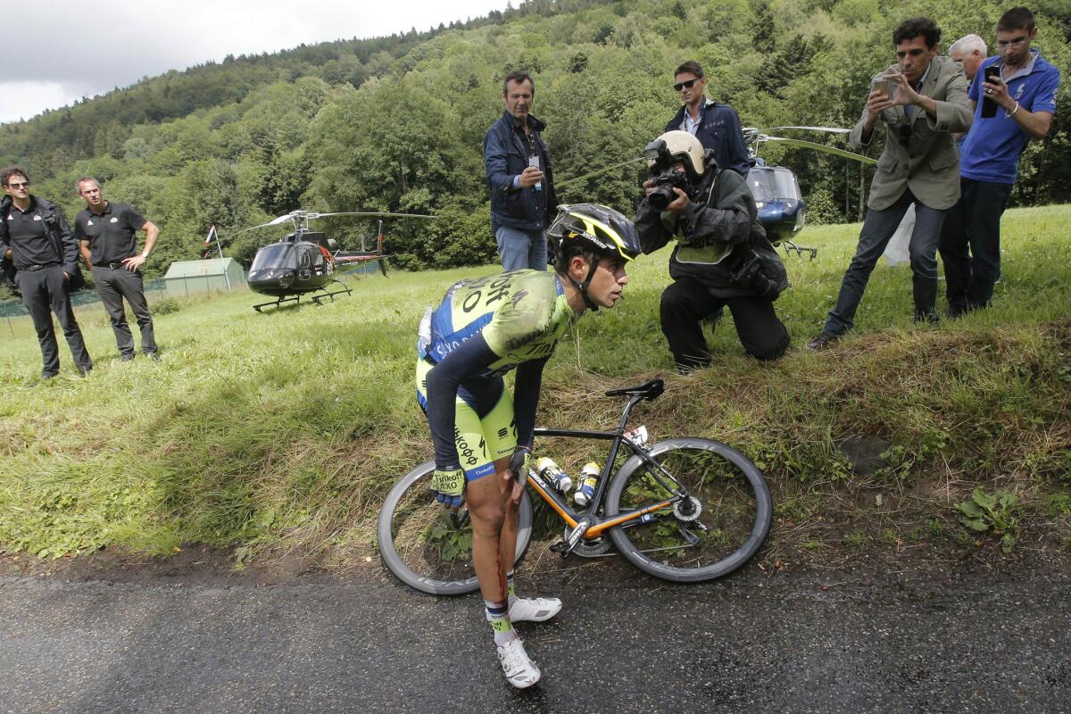 Spain's Alberto Contador holds his knee after crashing during Stage 10 of the Tour de France on Monday.