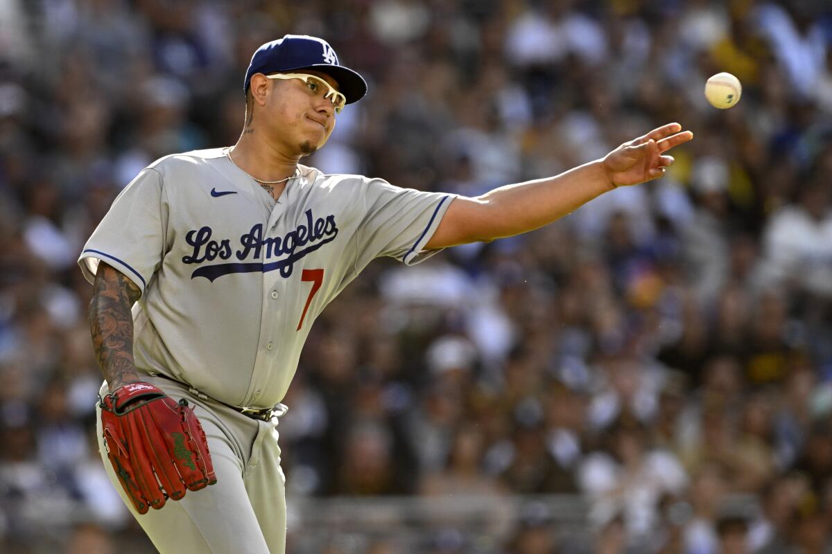 Dodgers pitcher Julio Urías throws to first during a game against the San Diego Padres on May 7.