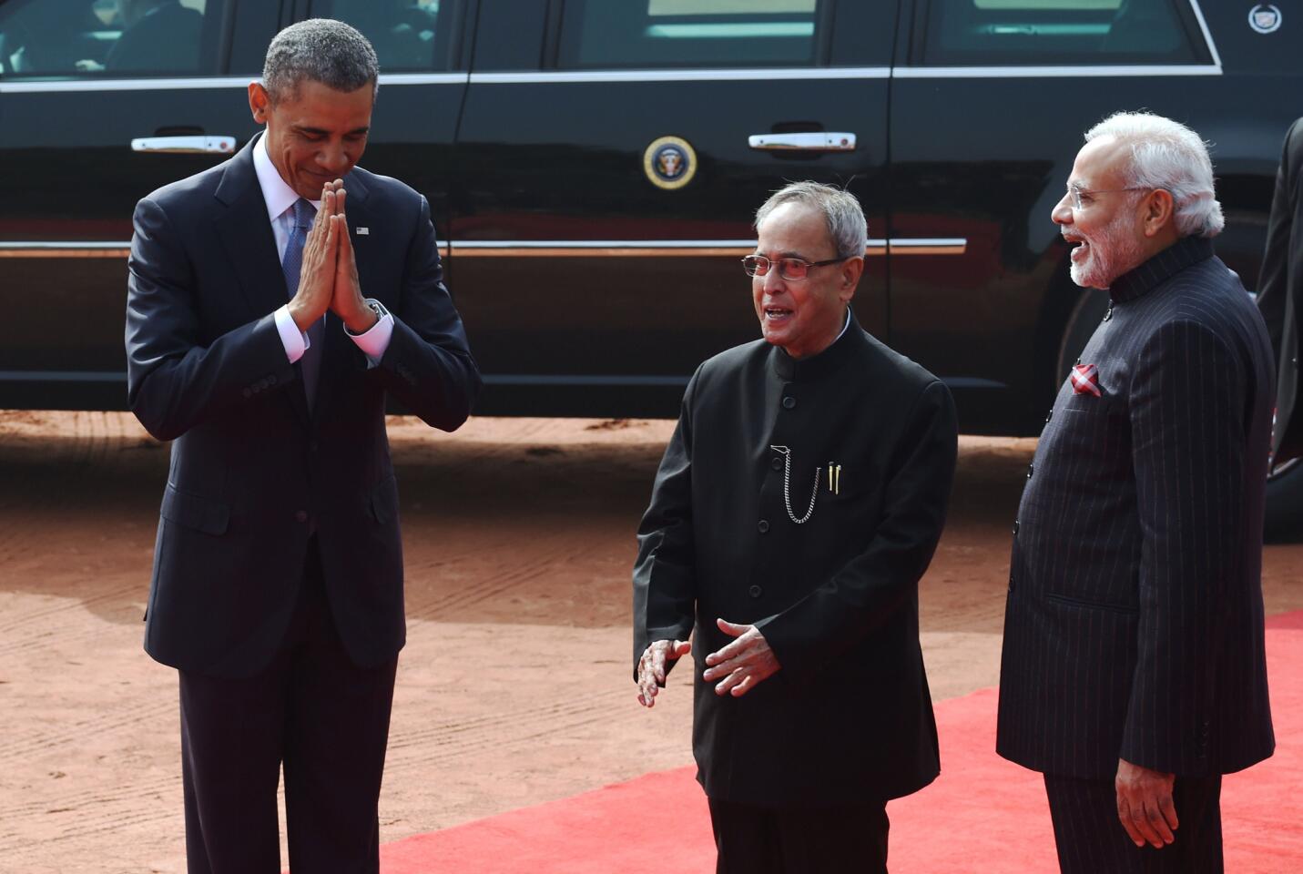 President Obama shares greetings with Indian President Pranab Mukherjee, center, and Prime Minister Narendra Modi at the presidential palace in New Delhi.