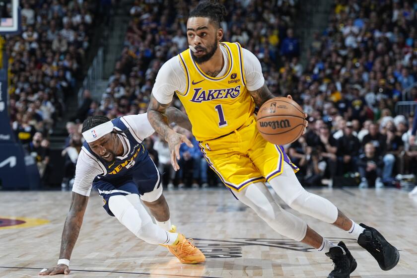Los Angeles Lakers guard D'Angelo Russell (1) drives past Denver Nuggets guard Kentavious Caldwell-Pope in the second half of Game 5 of an NBA basketball first-round playoff series Monday, April 29, 2024, in Denver. (AP Photo/David Zalubowski)