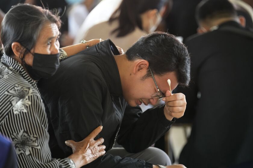 Seksan Sriraj, 28, grieves during a ceremony for those killed in the attack on the Young Children's Development Center in the rural town of Uthai Sawan, north eastern Thailand, Friday, Oct. 7, 2022. Seksan lost his pregnant wife who was a teacher at the day care center when it was attacked by a former policeman Thursday. (AP Photo/Sakchai Lalit)