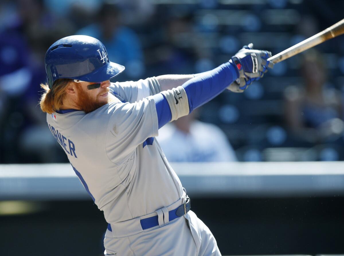 Dodgers third baseman Justin Turner hits a single off Colorado Rockies reliever John Axford during a game June 2.