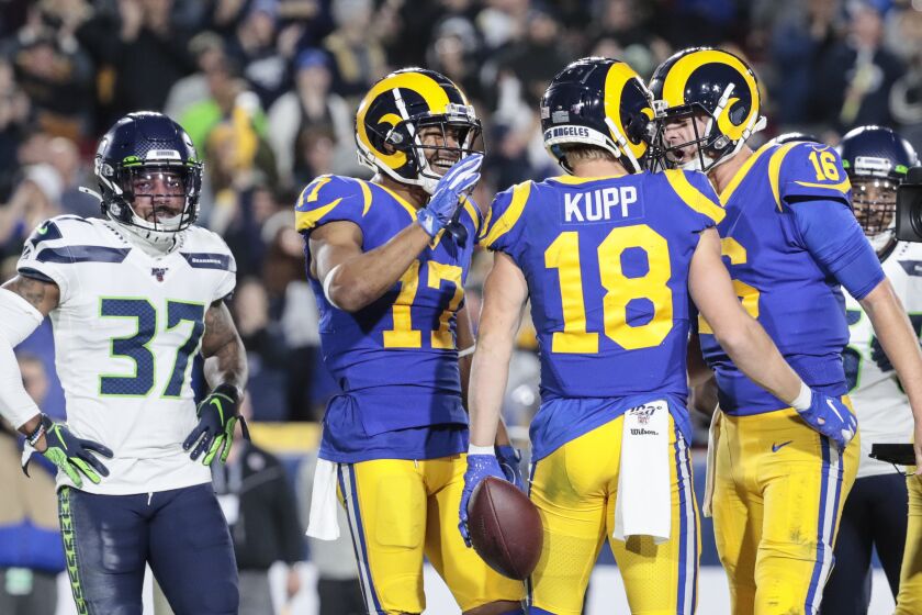 LOS ANGELES, CA, SUNDAY, DECEMBER 8, 2019 - Los Angeles Rams quarterback Jared Goff (16) celebrates after throwing a touchdown pass to receiver Cooper Kupp (18) against the Seattle Seahawks at LA Memorial Coliseum. (Robert Gauthier/Los Angeles Times)