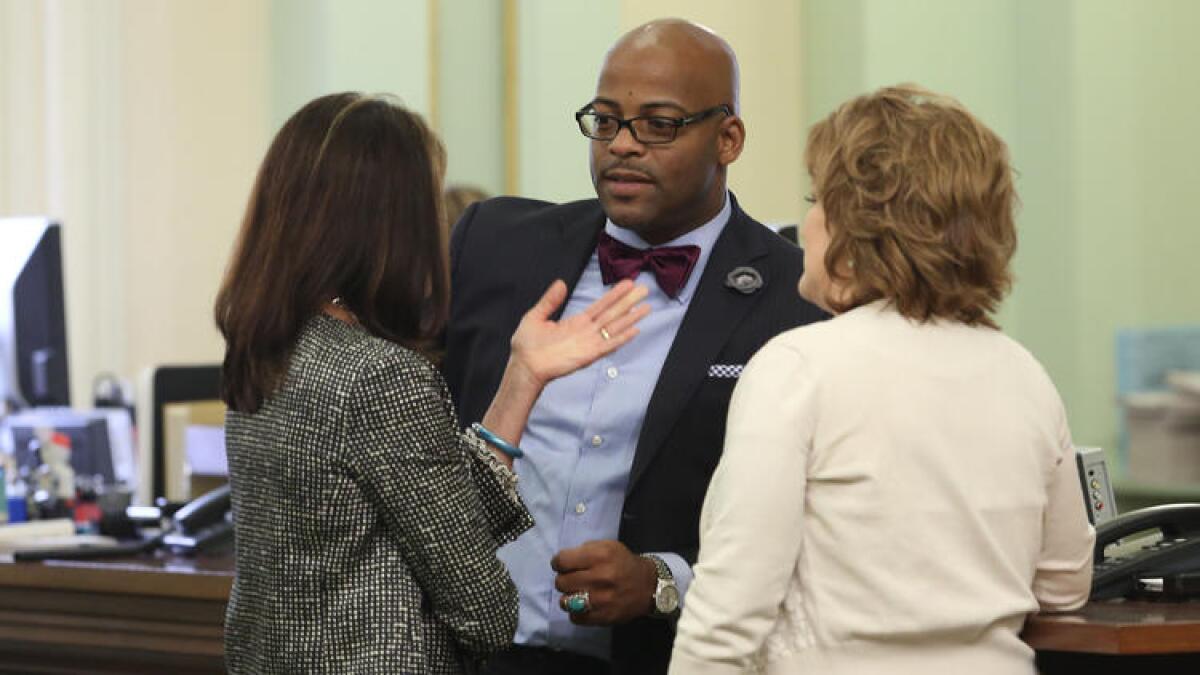 Sen. Isadore Hall III (D-Compton), center, speaks to other lawmakers.