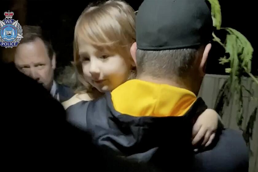 In this image made from a video released by Western Australia Police, a police officer carries rescued girl Cleo Smith in Carnarvon, Australia Wednesday, Nov. 3, 2021. Police smashed their way into a suburban house on Wednesday and rescued the girl whose disappearance from her family's camping tent on Australia's remote west coast more than two weeks ago both horrified and captivated the nation. (Western Australia Police via AP)