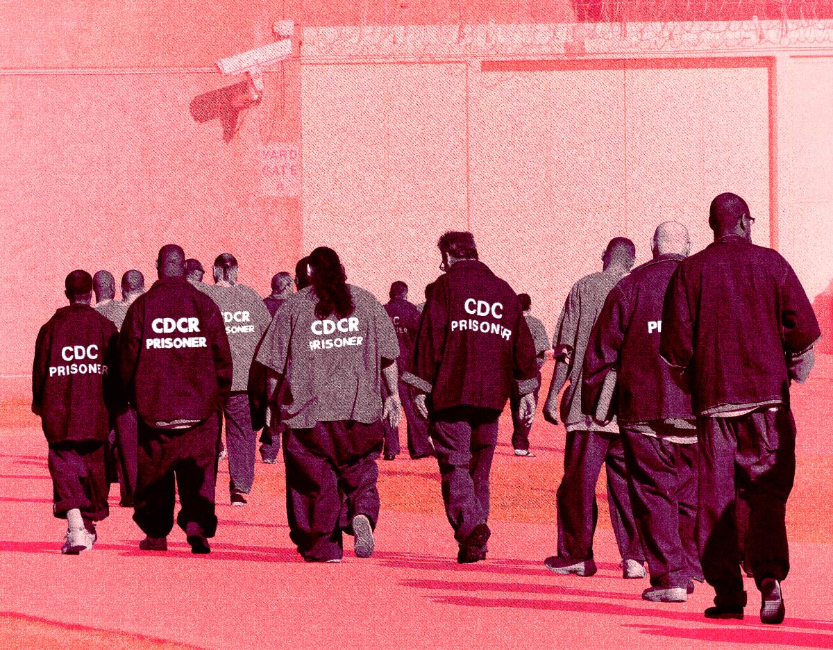 Inmates walk through an exercise yard at California State Prison, Sacramento.