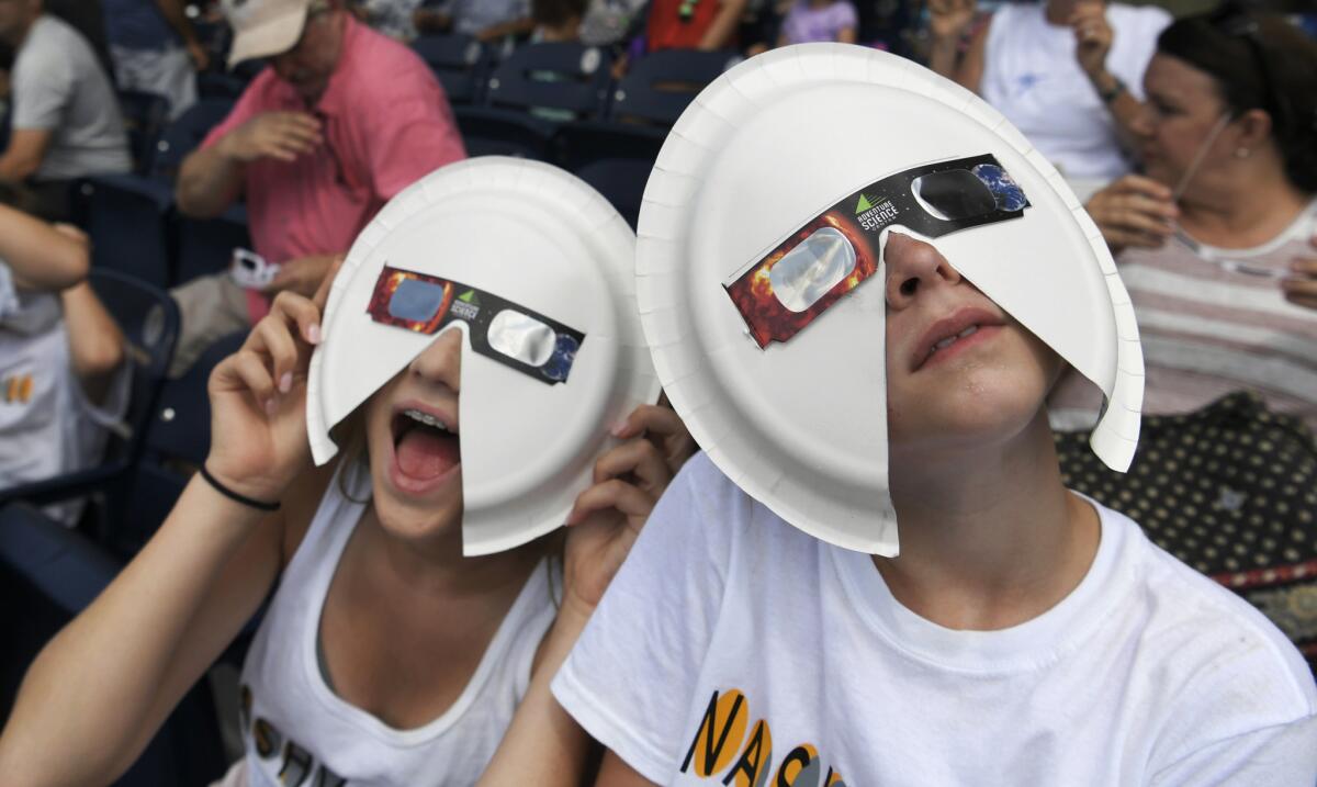 Eclipse viewers wear their makeshift safety glasses during a public party in Nashville on Aug. 21.