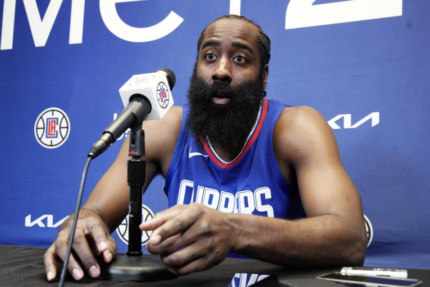 James Harden responds to a reporter's question as he is introduced as the newest member.