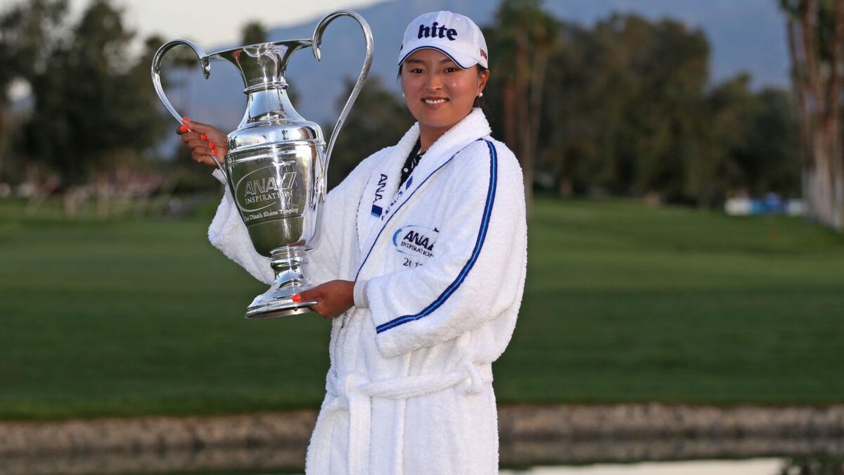 Jin Young Ko poses with the Dinah Shore Trophy after winning the ANA Inspiration tournament Sunday.