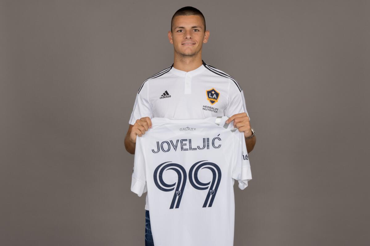  Dejan Joveljić holds up his new 99 jersey