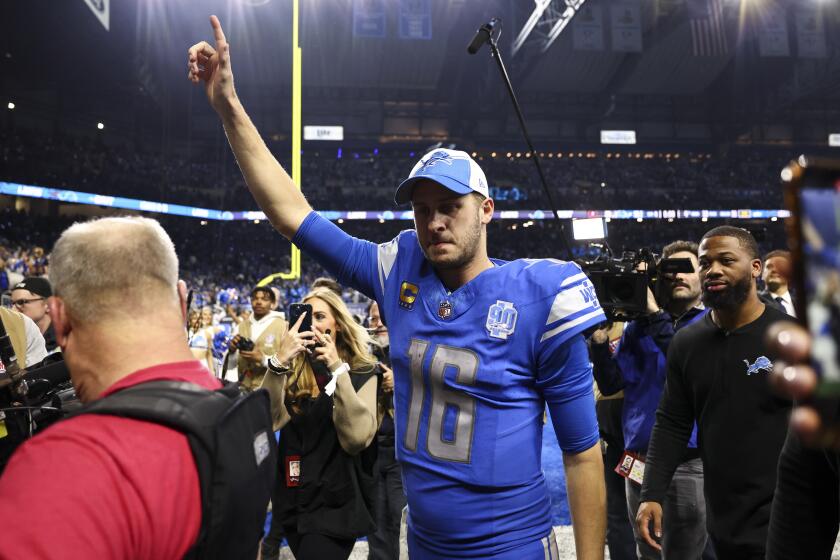 DETROIT, MI - JANUARY 21: Jared Goff #16 of the Detroit Lions celebrates while walking.