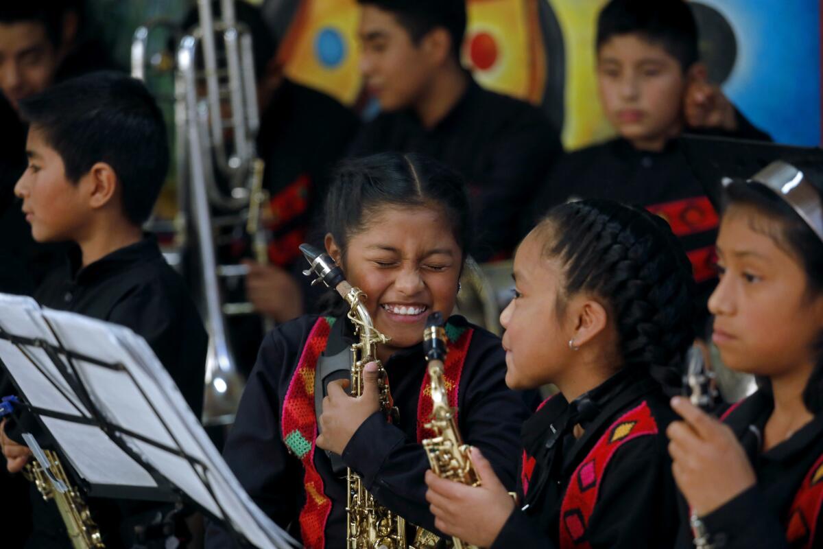 TLAXIACO, OAXACA -- SUNDAY, FEBRUARY 3, 2019: Damaris Hernandez Cruz, 10, second from left, and Janeth Gonzalez Sanjuan, 9, of La Banda Sinfonica de Tlaxiaco, after performing for Adriana Cecilia Aguilar Escobedo, secretary of culture and arts Oaxaca, at the Casa de la Cultura in Tlaxiaco, Oaxaca, on Feb. 3, 2019. Banda Sinfonica hopes to be selected to perform in the prestigious Guelaguetza annual indigenous cultural event. Yalitza Aparicio, 25, Mexican actress and schoolteacher who made her film debut in Alfonso Cuarón's 2018 drama Roma, which earned her an Academy Award nomination for Best Actress, is from the town of Tlaxiaco. Population around 17,000. (Gary Coronado / Los Angeles Times)