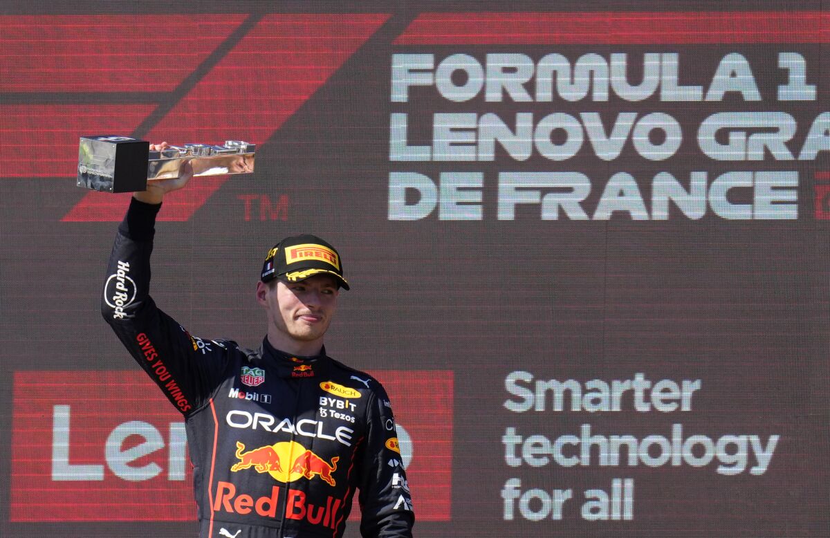 Max Verstappen holds up a trophy.