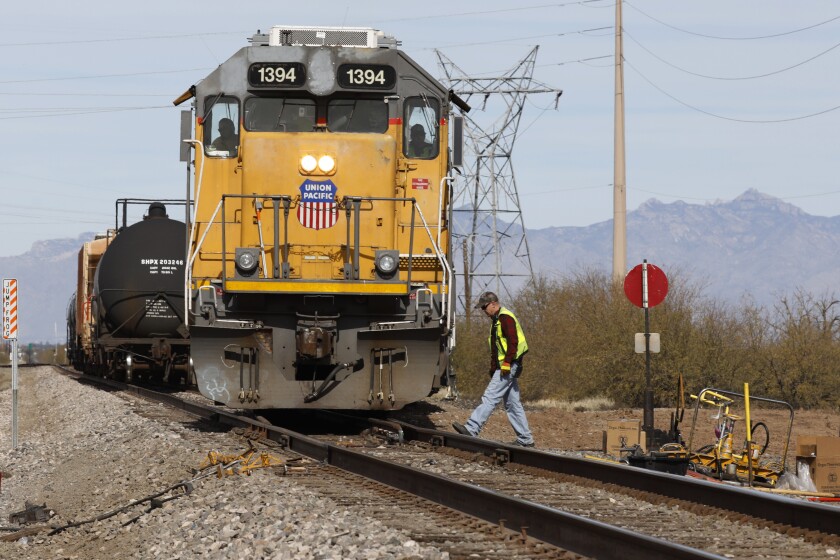 FILE - The crew on a Union Pacific freight train works at a siding area on Jan. 24, 2020, south of Tucson, Ariz. Contract talks between the major freight railroads and their unions are headed to mediation this week after the unions declared an impasse after more than two years of negotiations with the major freight railroads. (AP Photo/David Boe, File)