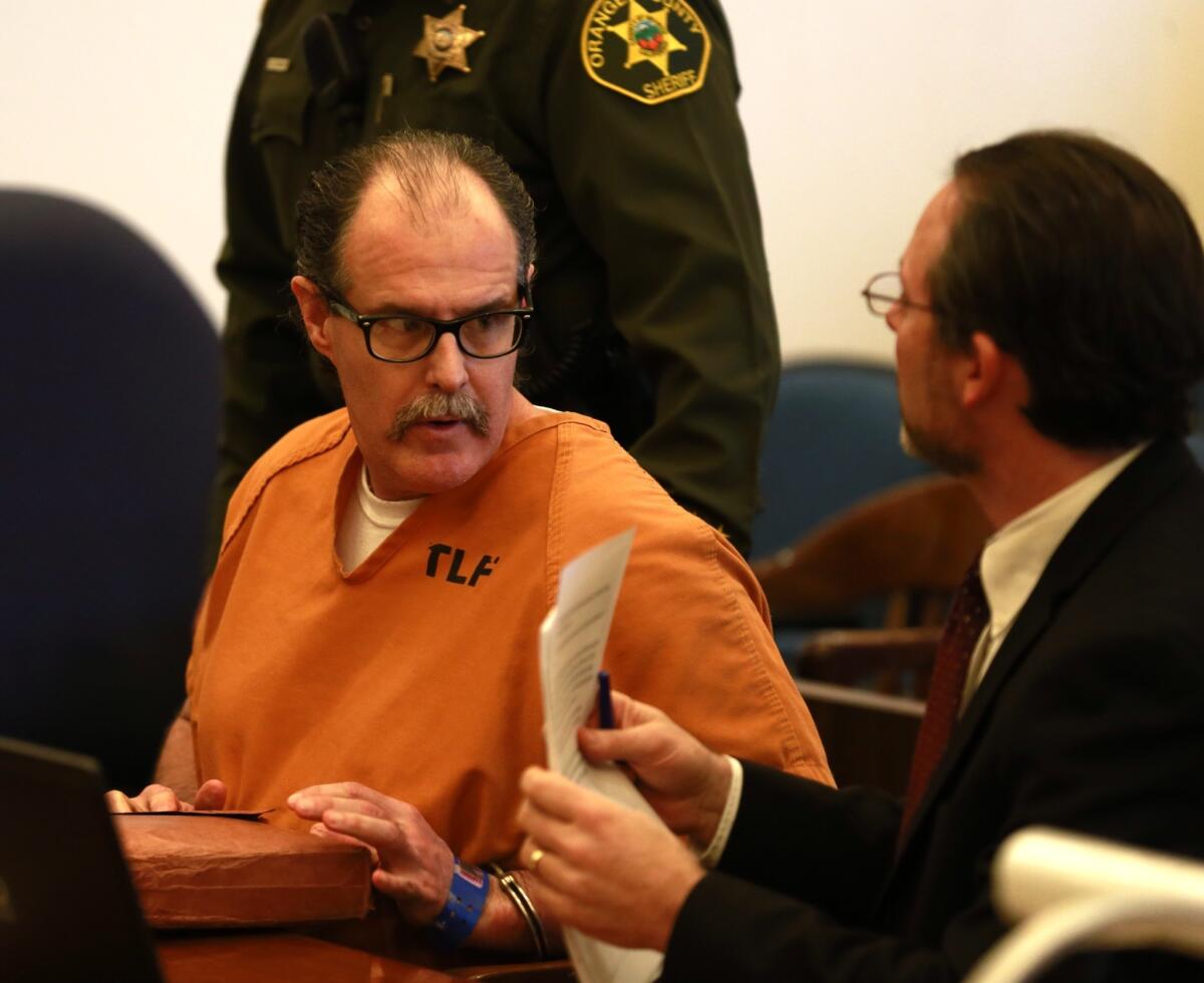 Public defender Scott Sanders, right, confers with his client, Scott Dekraai, left, during a court hearing to determine if Dekraai should be spared the death penalty.