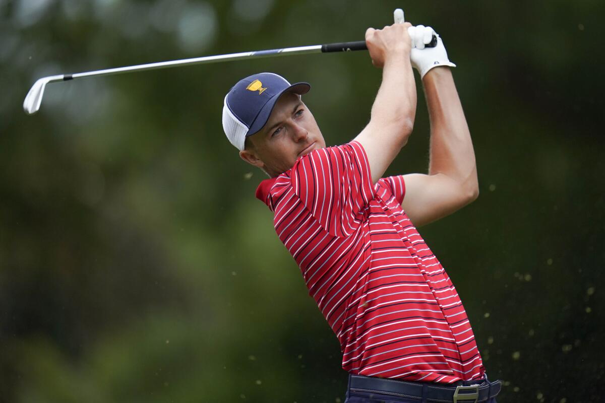 Jordan Spieth hits on the sixth hole during their singles match at the Presidents Cup golf tournament at the Quail Hollow Club, Sunday, Sept. 25, 2022, in Charlotte, N.C. (AP Photo/Julio Cortez)