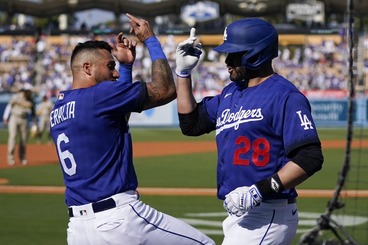 Dodgers designated hitter J.D. Martinez, right, celebrates with David Peralta.