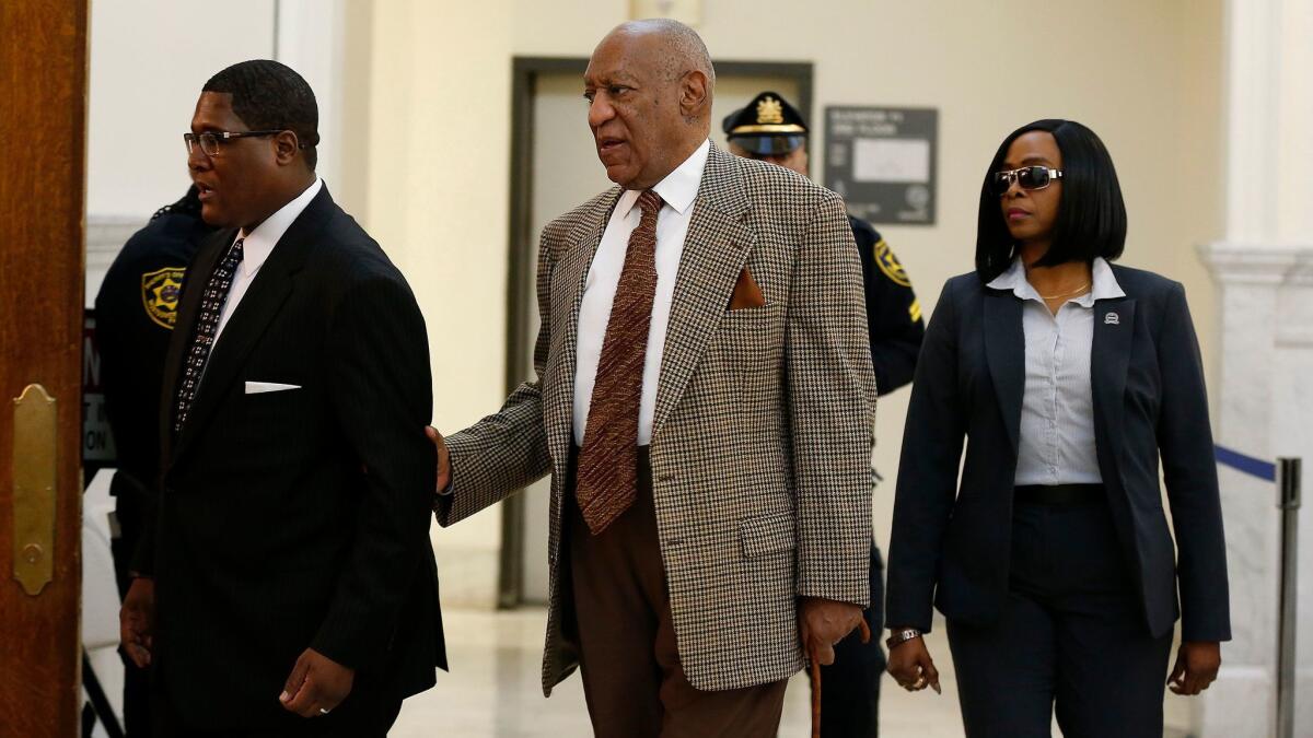 Bill Cosby, center, returns to court for a pretrial hearing in his sexual assault case at the Montgomery County Courthouse in Norristown, Pa., on Dec. 13.