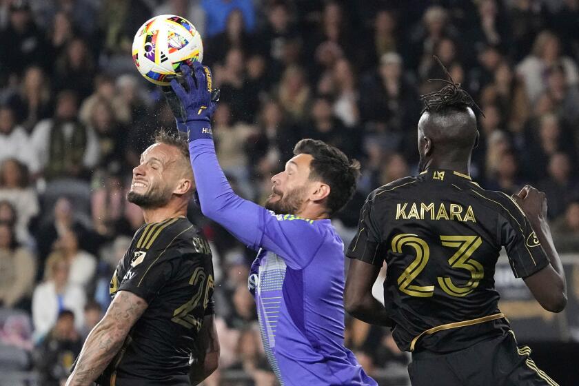 Los Angeles FC goalkeeper Hugo Lloris, center, stops a shot as defender Maxime Chanot, left, and forward Kei Kamara assist during the second half of a Major League Soccer match against FC Dallas Saturday, June 1, 2024, in Los Angeles. (AP Photo/Mark J. Terrill)