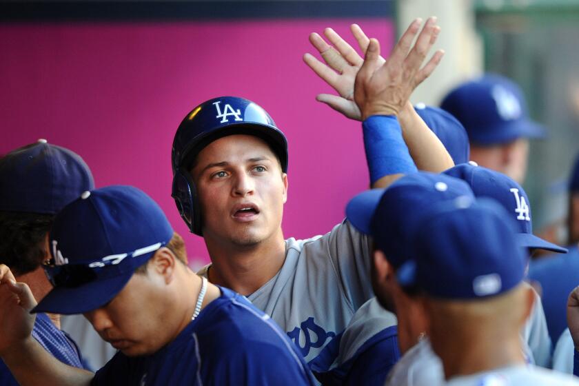 Dodgers rookie Corey Seager is congratulated after scoring a run against the Angels on Sept. 7.