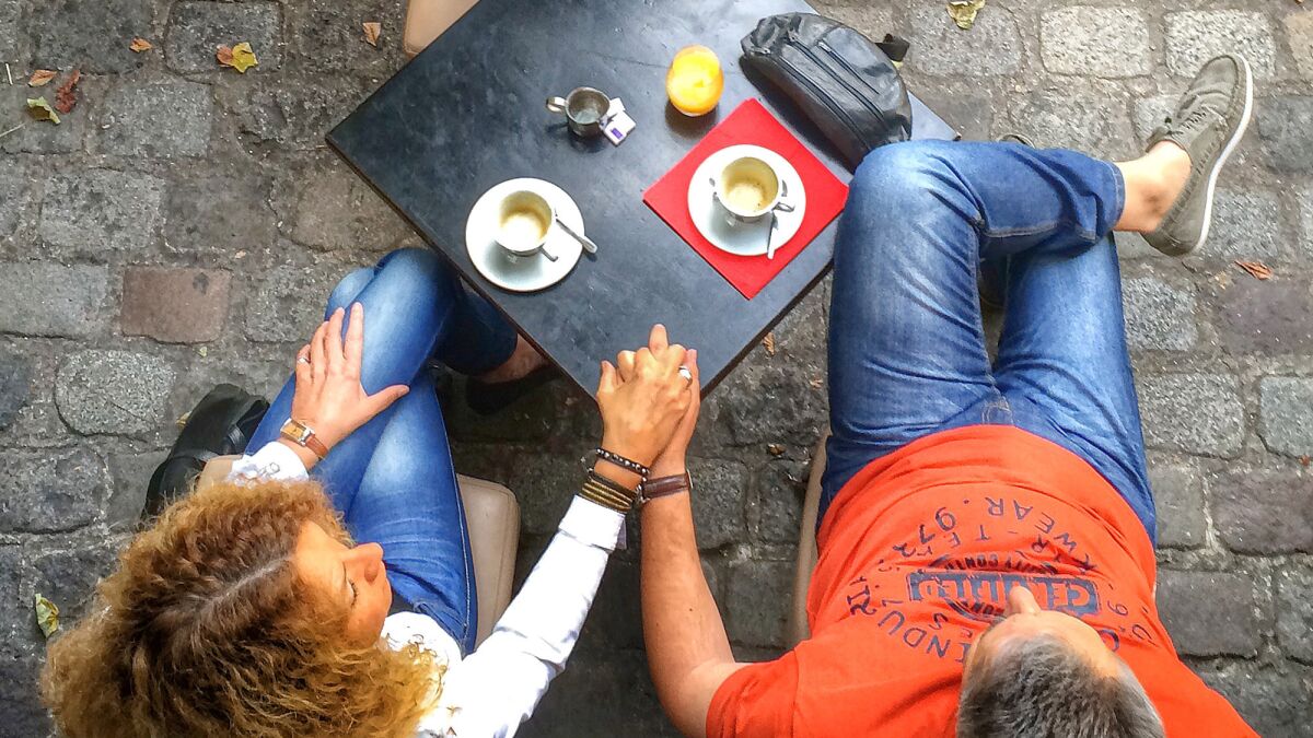 The online dating industry was worth more than $2 billion as of 2014 and growing at 5% each year. Above, a couple share a quiet moment at a Paris cafe.