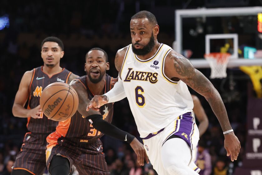 Los Angeles Lakers forward LeBron James (6) drives past Orlando Magic guard Terrence Ross (31) during the second half of an NBA basketball game in Los Angeles, Sunday, Dec. 12, 2021. The Lakers won 106-94. (AP Photo/Ringo H.W. Chiu)