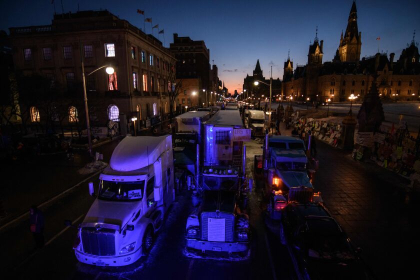 TOPSHOT - A general view shows trucks during a protest by truck drivers over pandemic health rules and the Trudeau government, outside the parliament of Canada in Ottawa on February 13, 2022. (Photo by Ed JONES / AFP) (Photo by ED JONES/AFP via Getty Images)