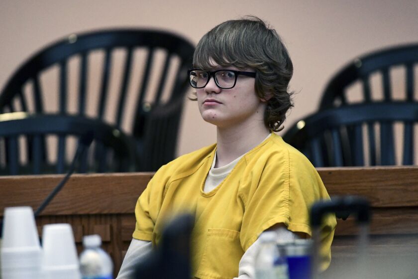 FILE - Jesse Osborne waits for a ruling at the Anderson County Courthouse, Feb. 16, 2018, in Anderson, S.C.. Osborne, a school shooter serving a life sentence without parole for killing a first grader on a South Carolina playground when he was 14 is asking a judge to lessen his sentence so he can eventually get out of prison. On Monday, May 22, 2023, Osborne's lawyer asked Judge Lawton McIntosh to reconsider his sentence so Osborne, now 21, could have some hope of freedom in his late 50s or even 60s. (Ken Ruinard/The Independent-Mail via AP, Pool, File)