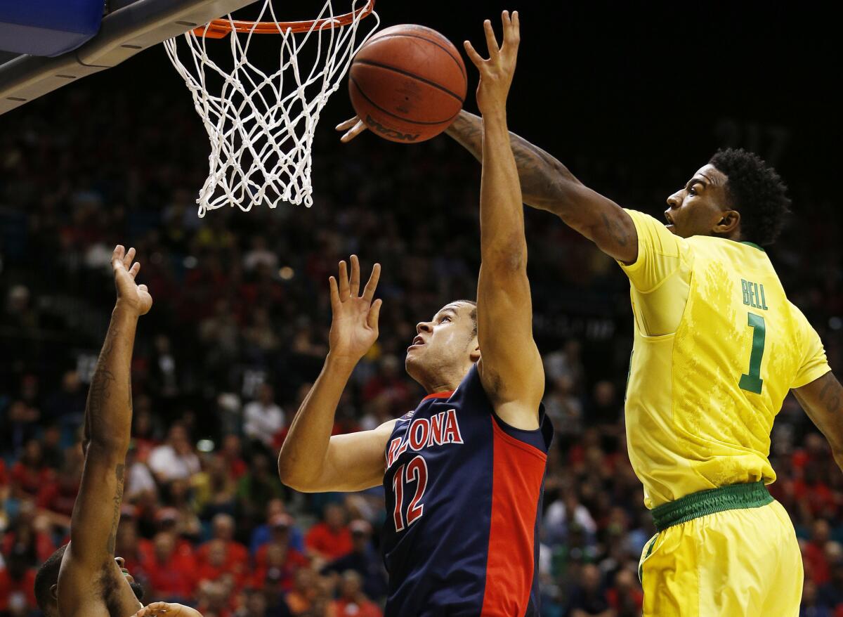 Oregon forward Jordan Bell knocks the ball out of the hands of Arizona forward Ryan Anderson during the first half of a Pac-12 Conference semifinal game on March 11.