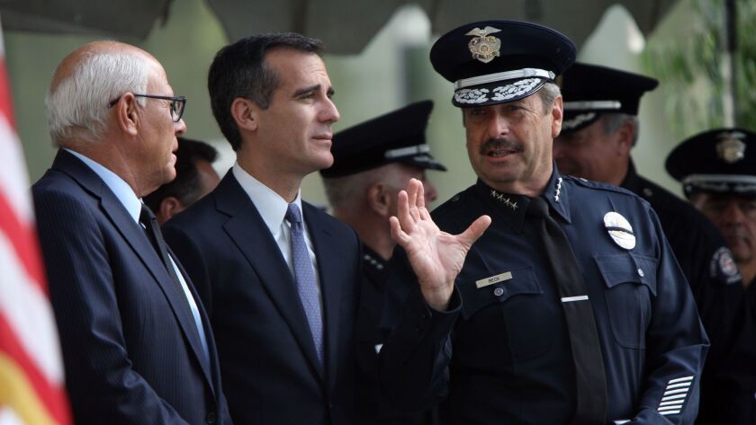 Police Commission President Steve Soboroff, Mayor Eric Garcetti and Police Chief Charlie Beck converse at an LAPD graduation ceremony in 2014.