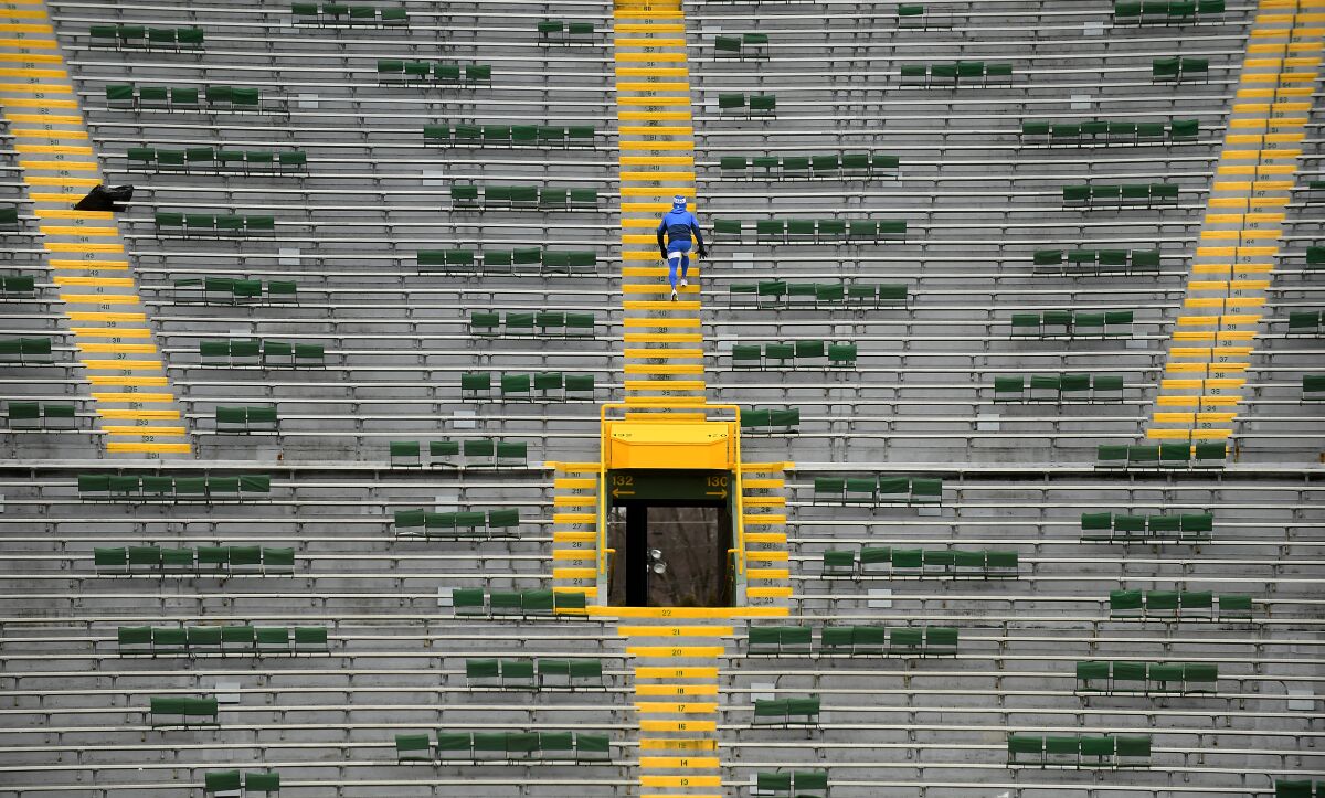Rams cornerbacks coach Aubrey Pleasant climbs the stairs at Lambeau Field before Saturday's NFC divisional playoff game.