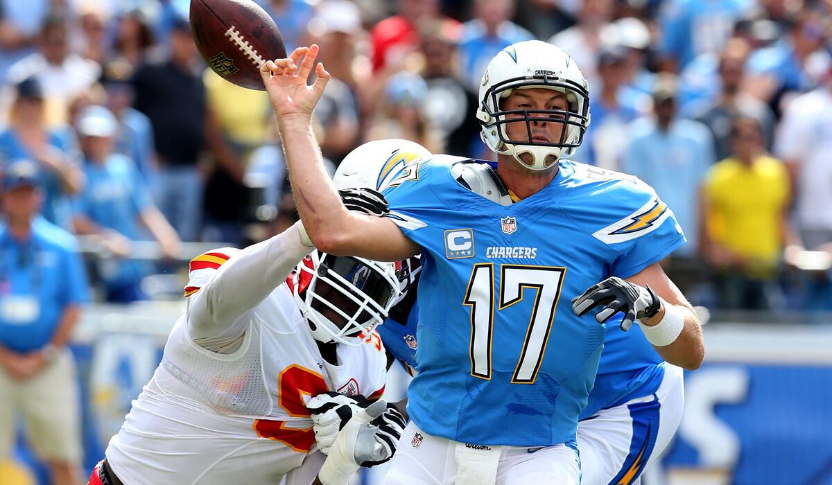 Chiefs defensive end Tamba Hall (91) forces a fumble by Chargers Philip Rivers as he attempts a pass in the second quarter Sunday in San Diego.