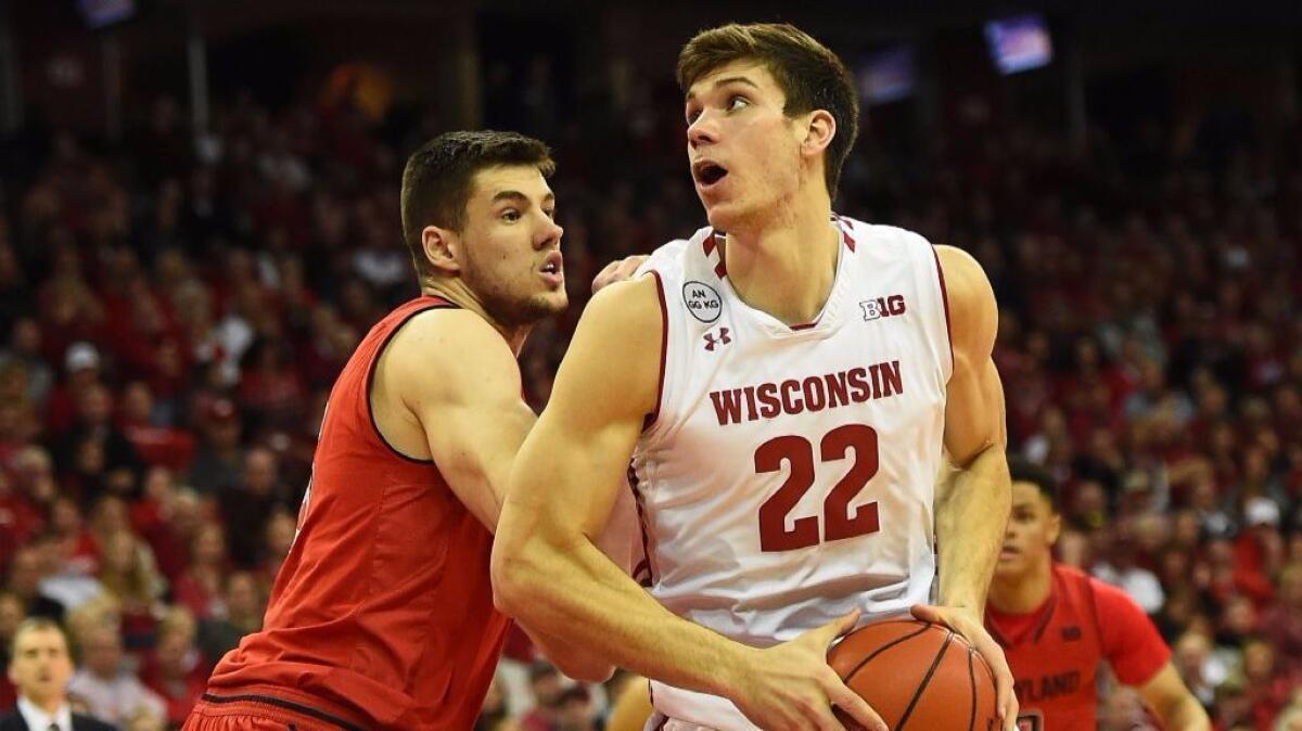 Wisconsin forward Ethan Happ (22) works against Maryland's Michal Cekovsky (15) during the first half on Feb. 19.