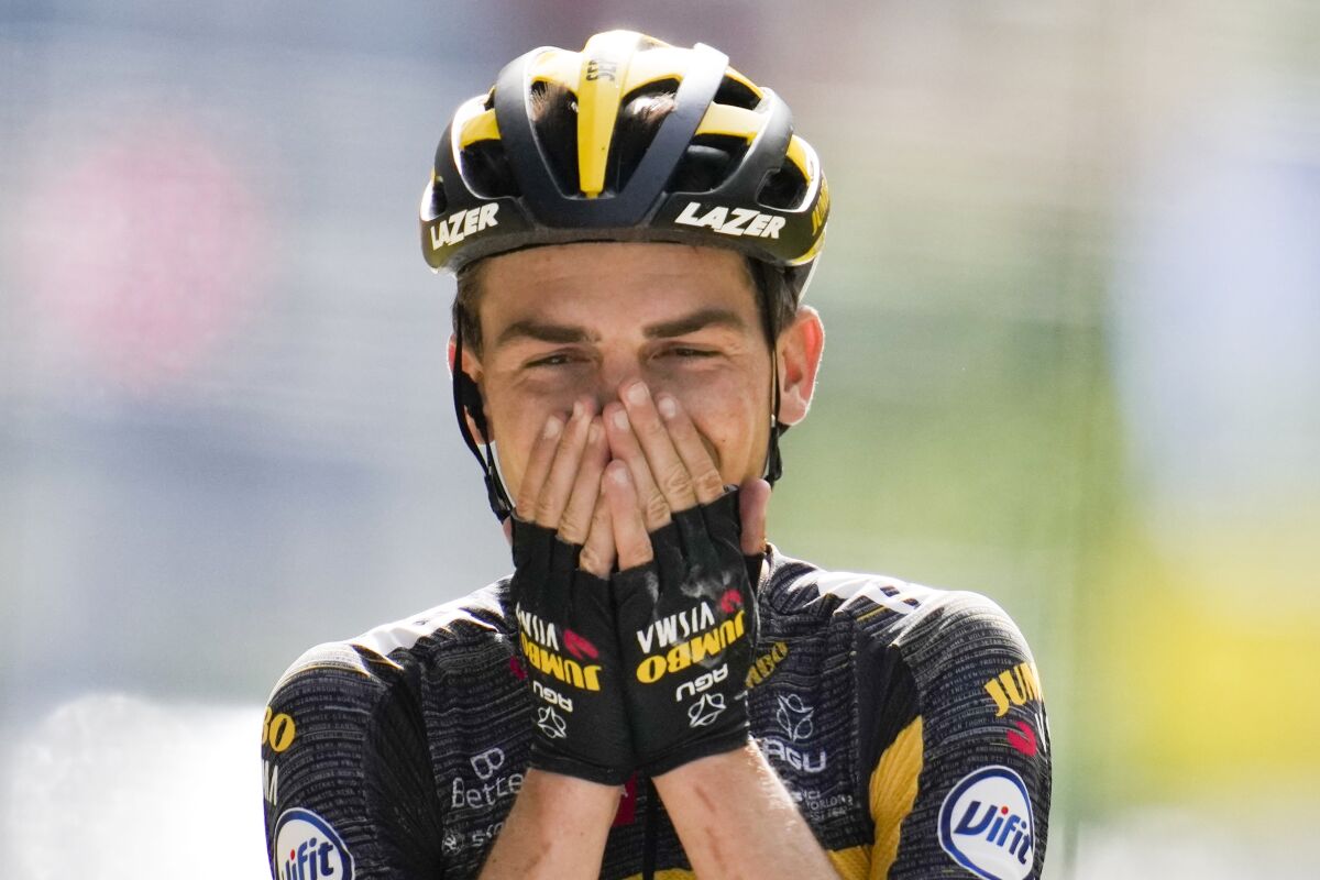 Sepp Kuss of the US celebrates as he crosses the finish line to win the fifteenth stage of the Tour de France cycling race over 191.3 kilometers (118.9 miles) with start in Ceret and finish in Andorra-la-Vella, Andorra, Sunday, July 11, 2021. (AP Photo/Christophe Ena)