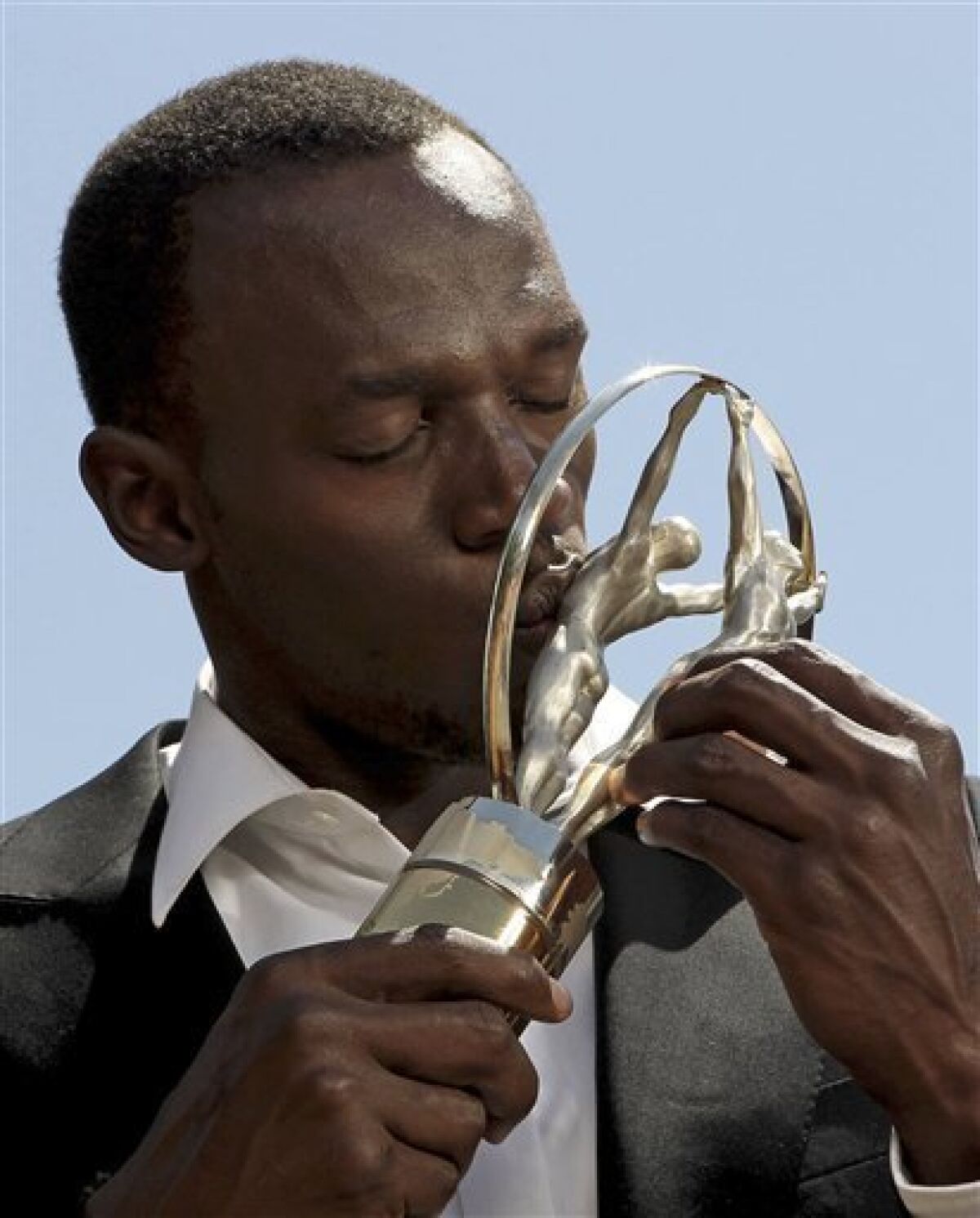 In this image released by the Laureus Awards on Wednesday March 10, 2010, Jamaican sprint star Usain Bolt kisses the Laureus World Sportsman of the Year Award in Kingston, Jamaica. Bolt who won the Laureus World Sportsman of the Year for the second year running, was unable to attend the awards ceremony in Abu Dhabi, UAE, on Wednesday. (AP Photo/Nick Laham, Getty Images for Laureus)
