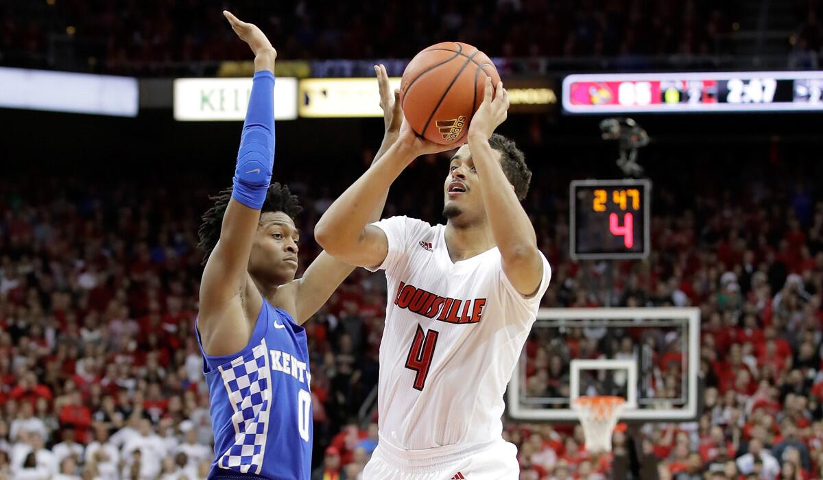 Louisville's Quentin Snider (4) shoots the ball during the game against Kentucky on Wednesday.