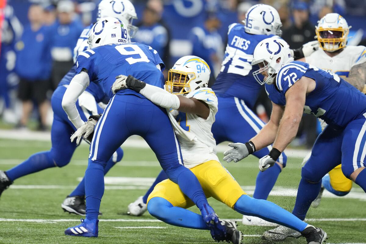 The Chargers' Chris Rumph II (94) records one of seven sacks of Colts quarterback Nick Foles.