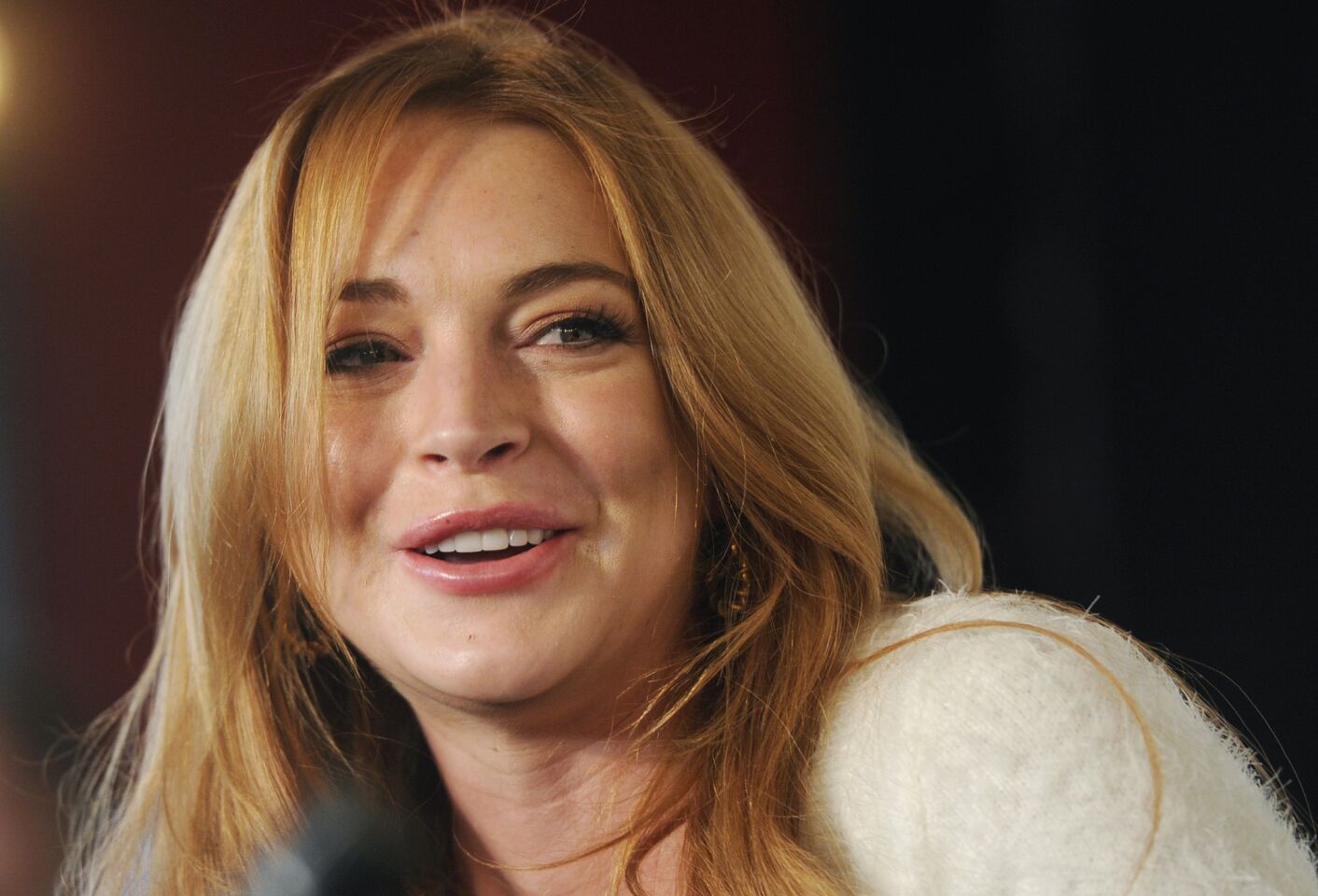 For once the attention shifted from Lindsay Lohan to her mother when Dina Lohan was arrested on suspicion of drunk driving in New York. But the attention swung right back to Lindsay when she arrived at her mother's home in a top with low, like really low, sides -- revealing much of her chest.