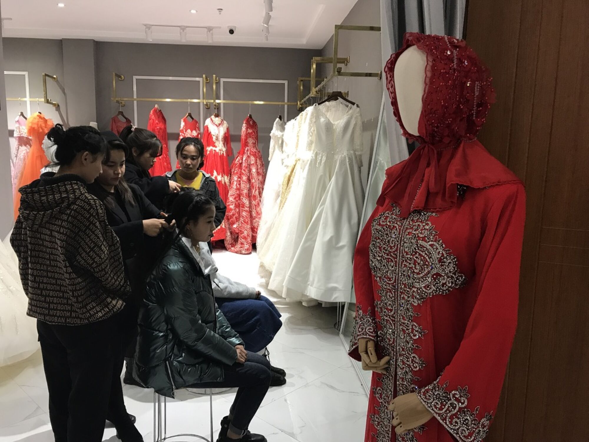 Young Dongxiang women receive training to become bridal hair and makeup artists at a vocational school.