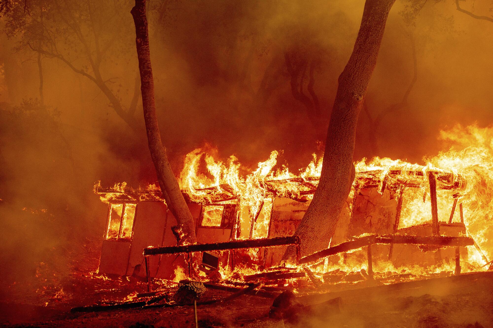 Flames consume a cabin at a Napa County winery.